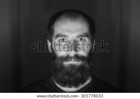 Portrait of tattooed bearded man wearing white blank t-shirt