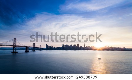 San Francisco skyline at sunset with solo boat