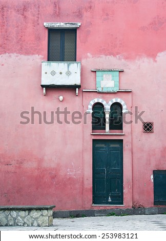 CAPRI, ITALY - OCTOBER, 12: Beautiful dark blue and white window and door on pink wall house background, October 12, 2010