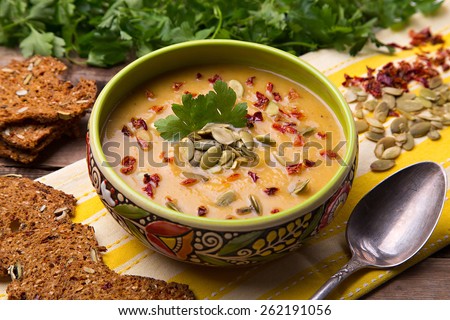 Homemade cream soup from baked butternut squash with thyme and paprika with parsley