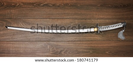 Katana, japanese sword, on wood background