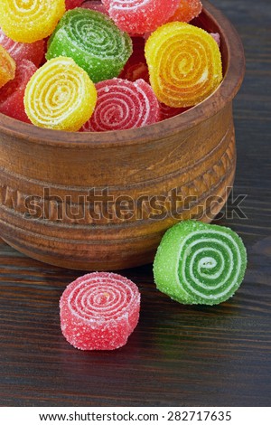 Sweet colorful candy on wooden background