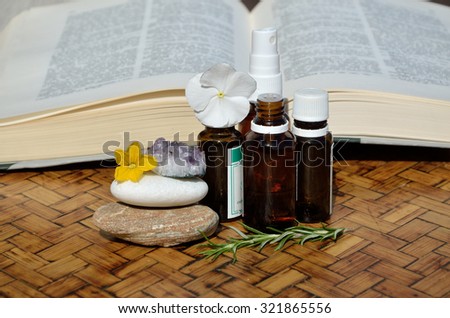 Bottles of homeopathic remedies with a remedy guide book