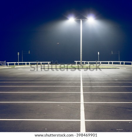 Parking lot with street light at night, filtered image