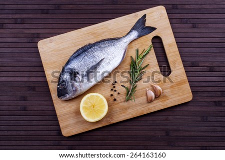 Fresh dorado fish cooking with spices and condiments - Stock image
