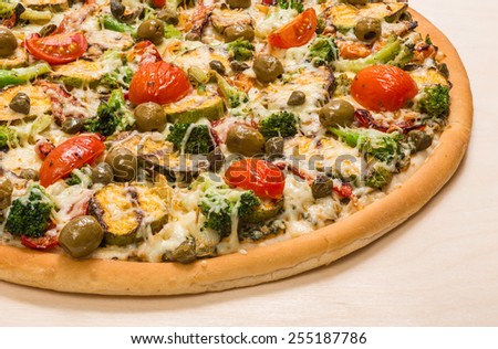 Part of pizza with vegetables and cheese