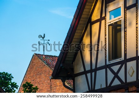 Old houses in germany village. Weather vane on background. Foreground is out of focus