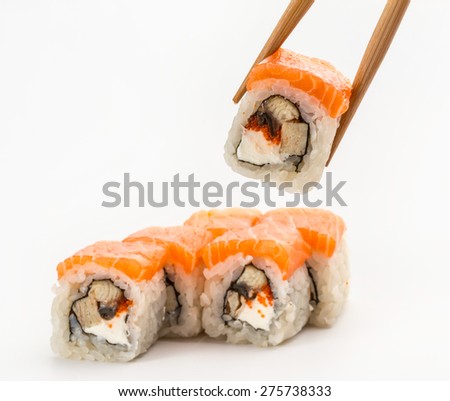 Japanese Cuisine - Maki Sushi with Salmon and Eel one in chopsticks. Sushi and Rolls with Seafood, Vegetables, Cream Cheese, isolated on a white background