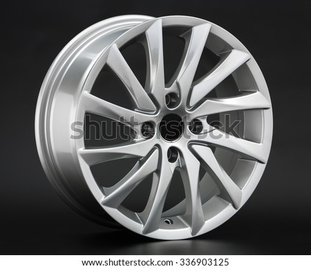 Aluminum metal wheel rim texture. Car alloy wheel, isolated on black background
