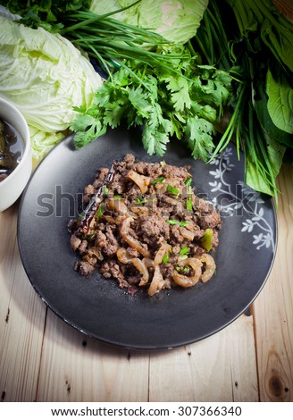 Ground Pork cook and  vegetable ,thai style  on wood table.   Thai food