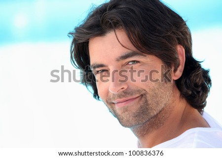 portrait of handsome man at sea resort