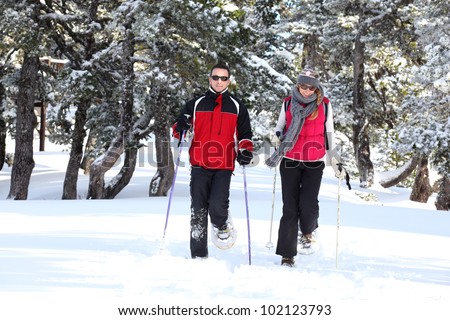 Couple walking in snowshoes