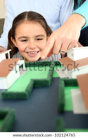 Child looking at a model of a housing estate