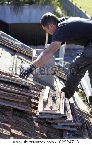 Roofer repairing a badly damaged roof