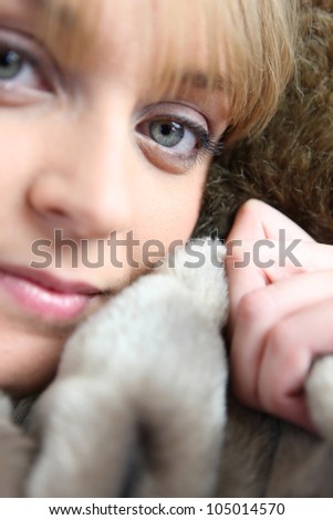 Woman snuggling up to a blanket