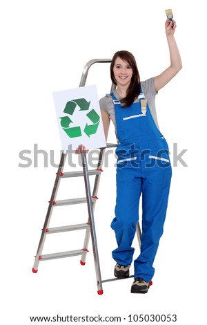 Woman stood with recycle logo and paint brush