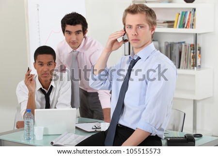 Three businessman working on a project.