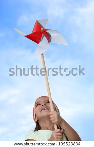 Little girl playing with windmill toy