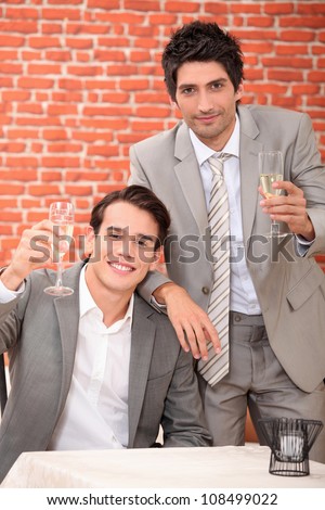 Two men toasting with champagne