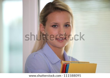 young businesswoman holding folders