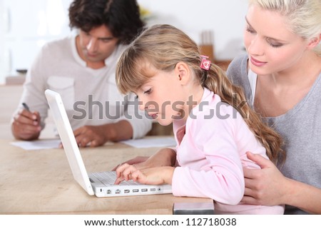 Parents with daughter on computer