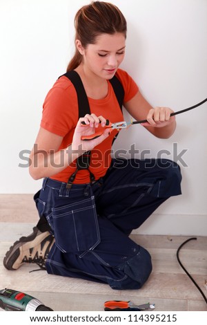 handywoman using stripping pliers on a wire