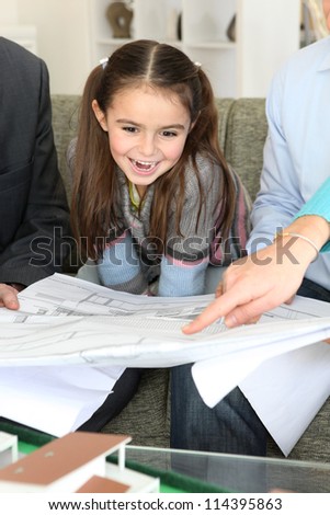 Architect showing designs to young family