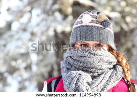 Women covering her face with scarf to keep warm