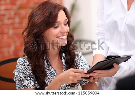 Woman watching the bill in a restaurant