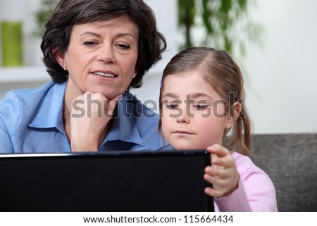 Young girl surfing the Internet with her grandmother