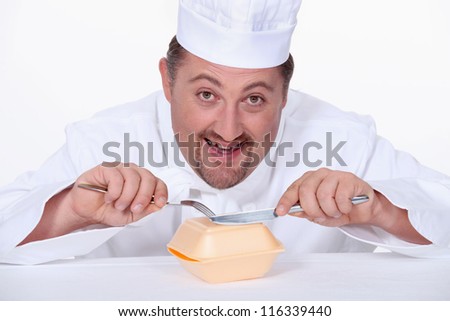 Chef eating a polystyrene foam takeaway box