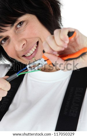 Woman pulling wires using a pair of pliers