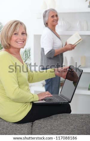 Older women with computer and book