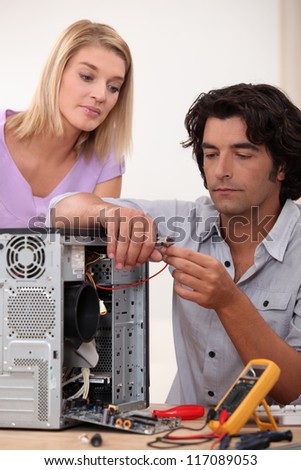 Man repairing PC for colleague