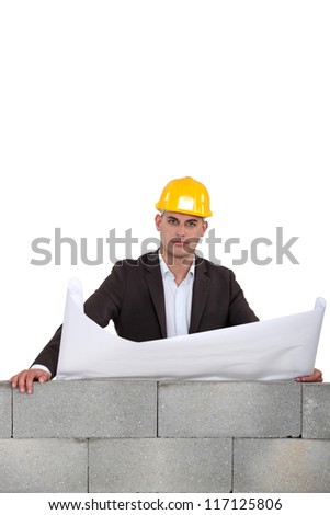 Architect looking over wall
