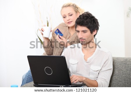 young couple shopping online with bank card