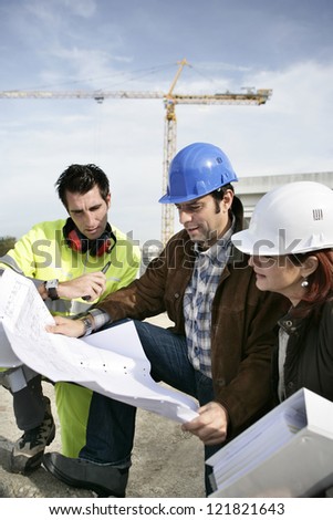 Construction team looking at plans