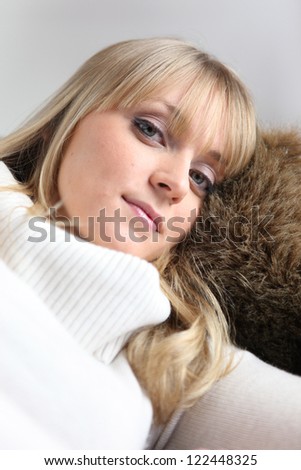 Woman snuggled up indoors
