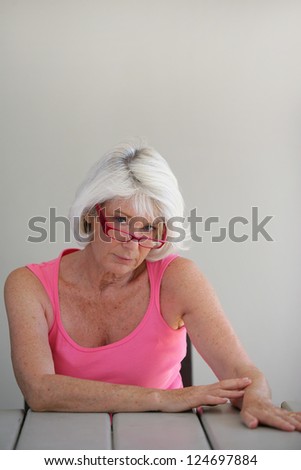 Sad middle-aged lady sat at a table
