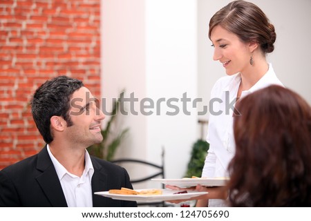 Waitress serving dishes