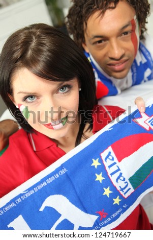 mixed race couple of italian soccer supporters