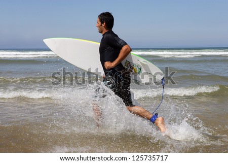 Surfer running with board