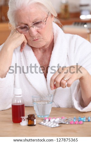 Elderly lady sat with her medication