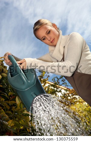 Young woman with a watering can