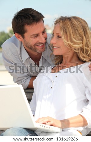 Man behind woman with computer