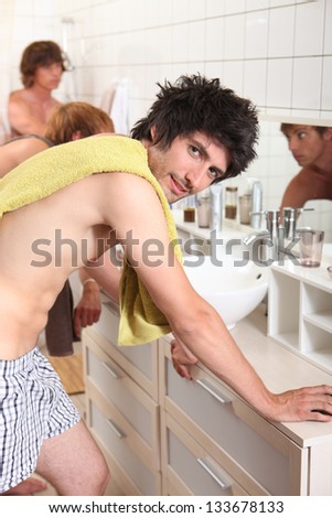 Three men sharing bathroom