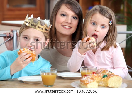 Mother and daughters eating cake