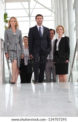 Group of executives climbing stairs