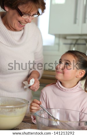 Little girl cooking with grandma