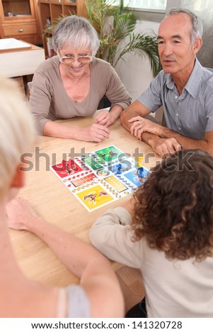 Family playing board game together